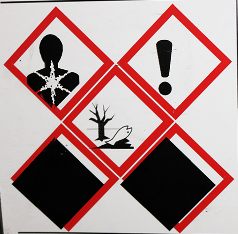 Chemical label with red diamonds overprinting with thermal printer that is not central