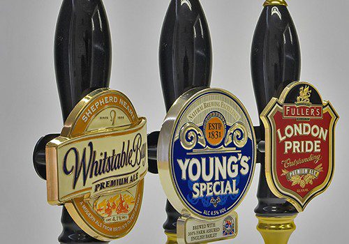 Moulded and enamelled beer pump badges