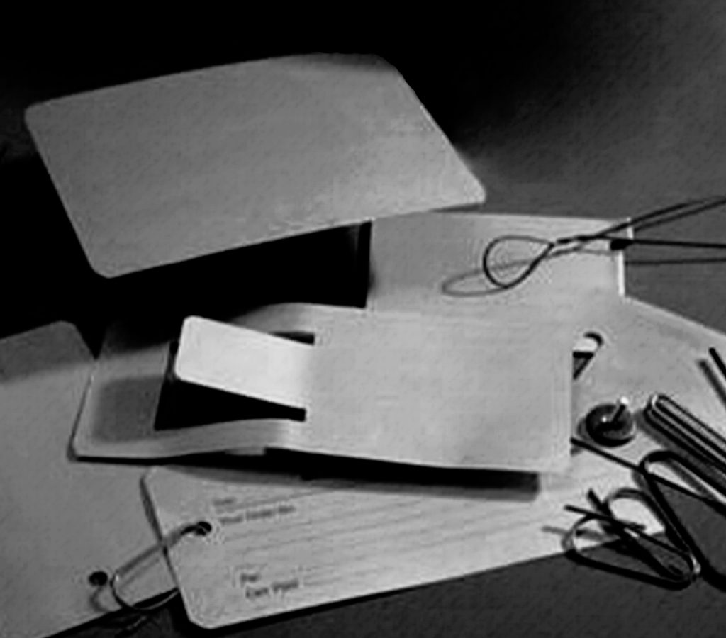 Pile of traditional metal tags with fixings
